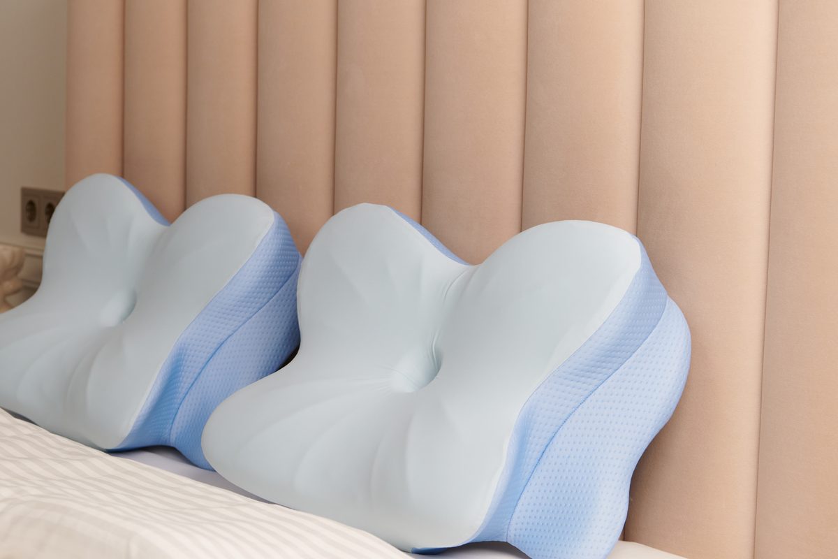 Two Derila Ergo memory foam pillows on a bed showing the butterfly contour shape